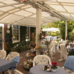 Seats in front of the café beneath the sunshade